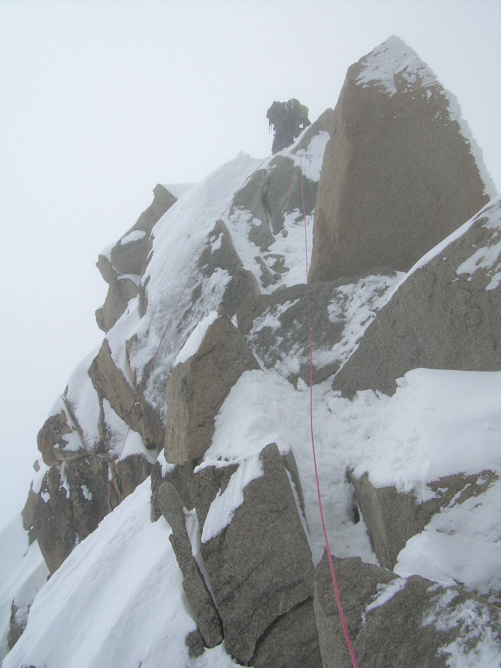 Lazell emerging over rocks, Cosmiques Arete.JPG